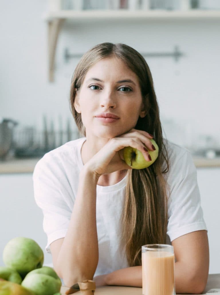 Patient enjoying fresh fruit in a bright kitchen